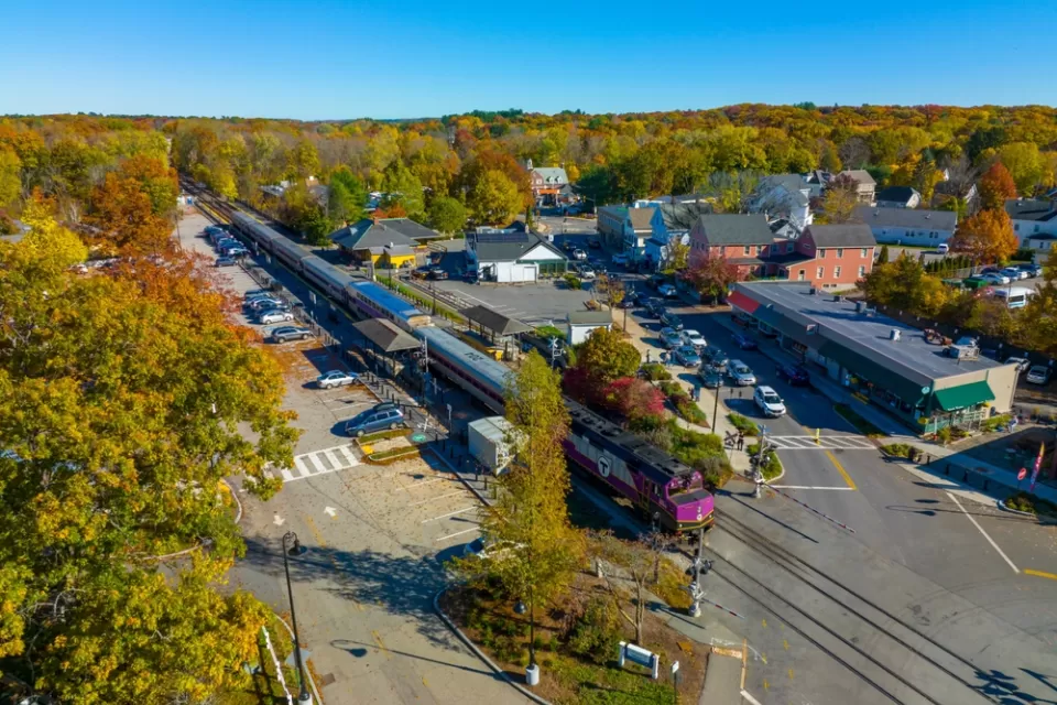 Aerial view of MBTA commuter rail station in Concord, Massachusetts among green trees